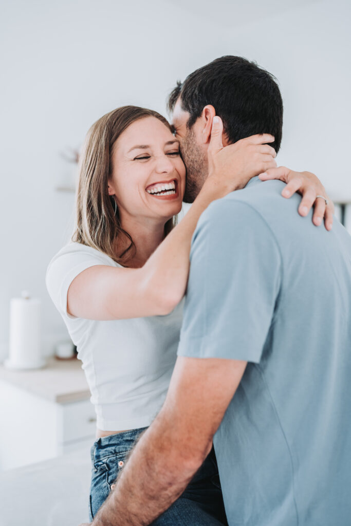 couple prompt whispering into ear