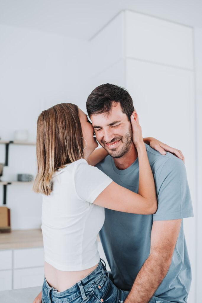 couple prompt whispering into ear