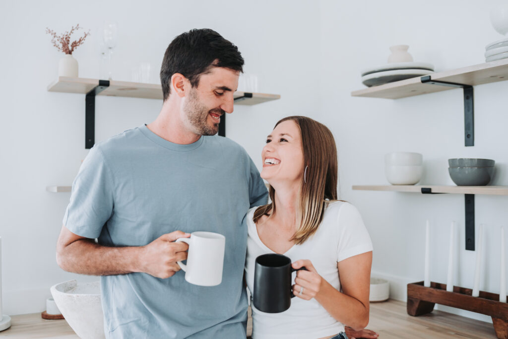Couple holding mugs in the kitchen at kiah studios
