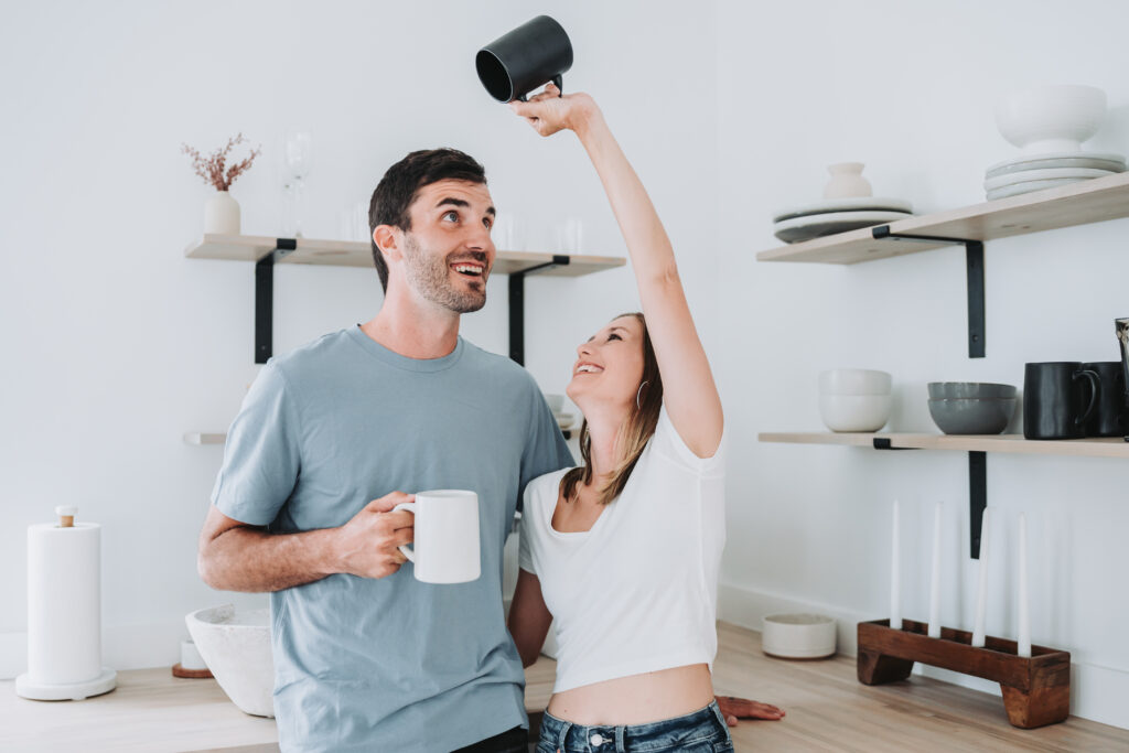 Couple holding mugs in the kitchen at kiah studios