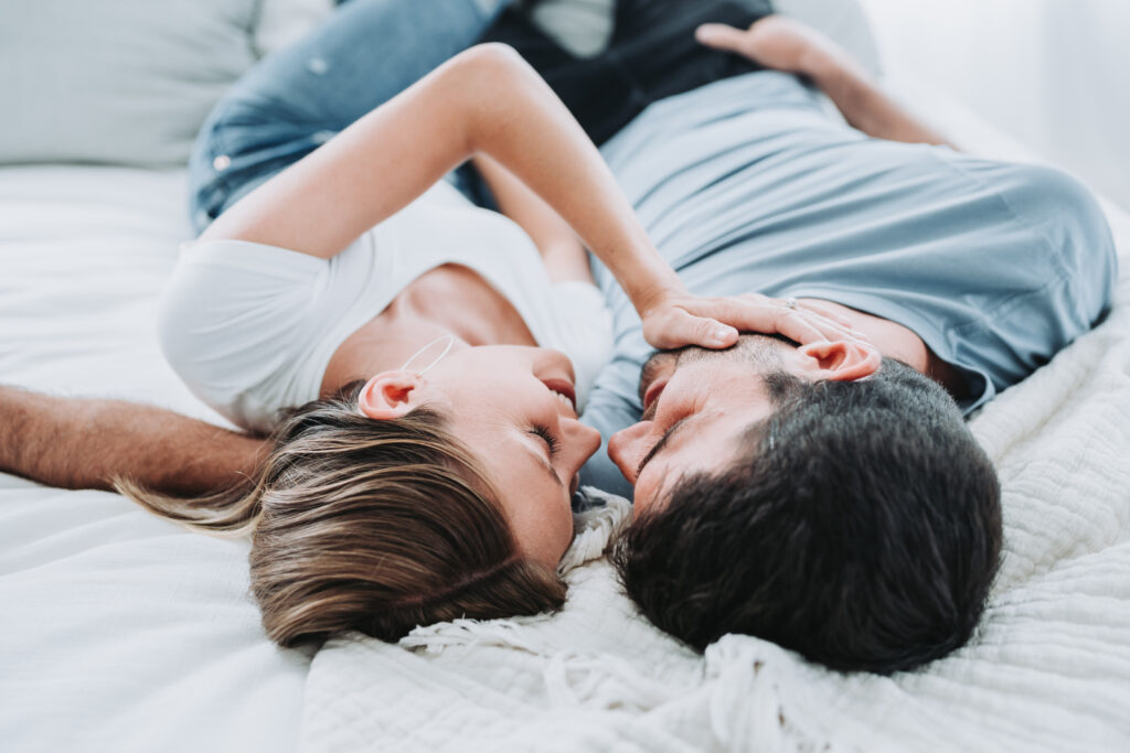 couple laying on bed 