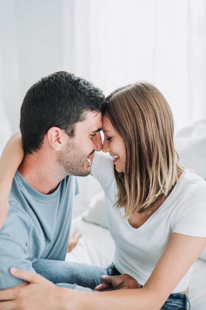 couple embrace on bed