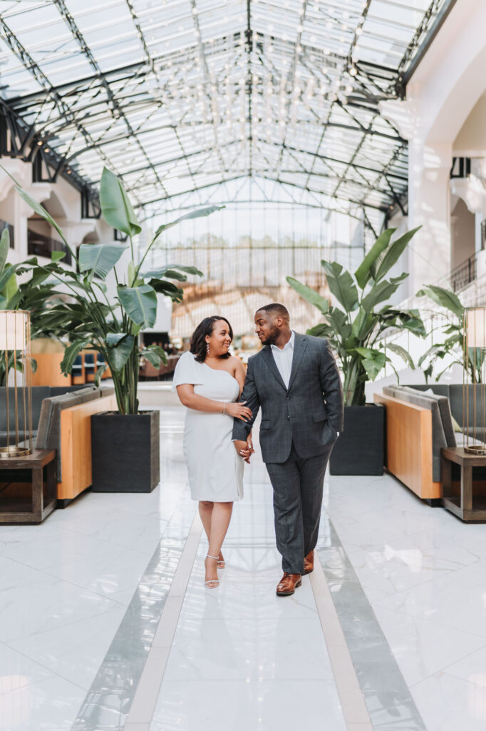 Couple walks towards camera at Chateau Elan engagement photoshoot.