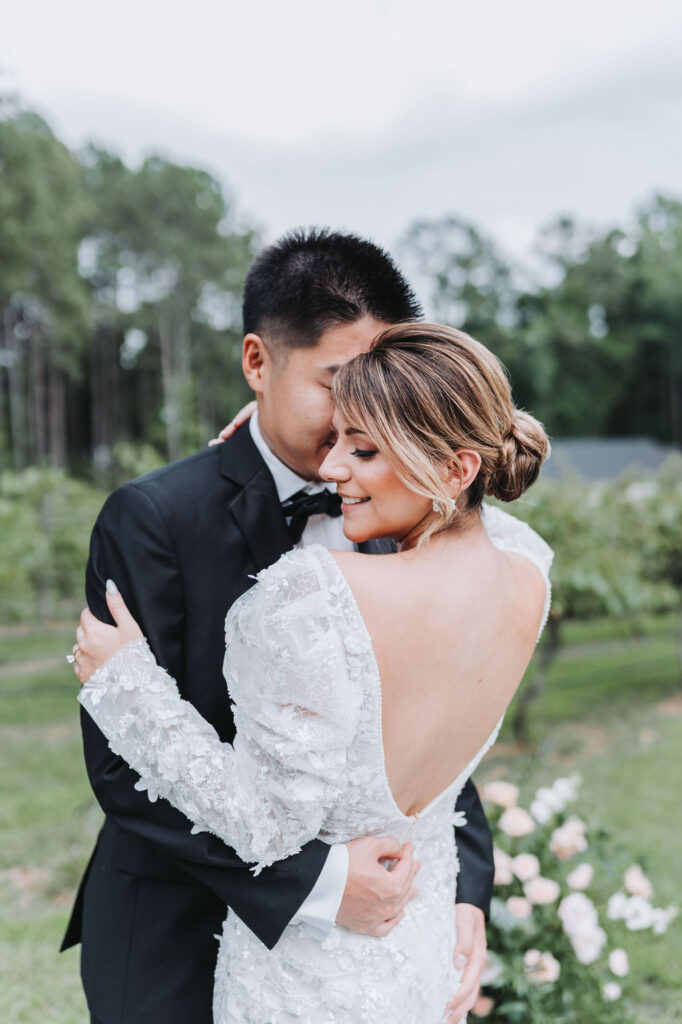 Bride and groom hold each other. Wedding at Koury Farms.