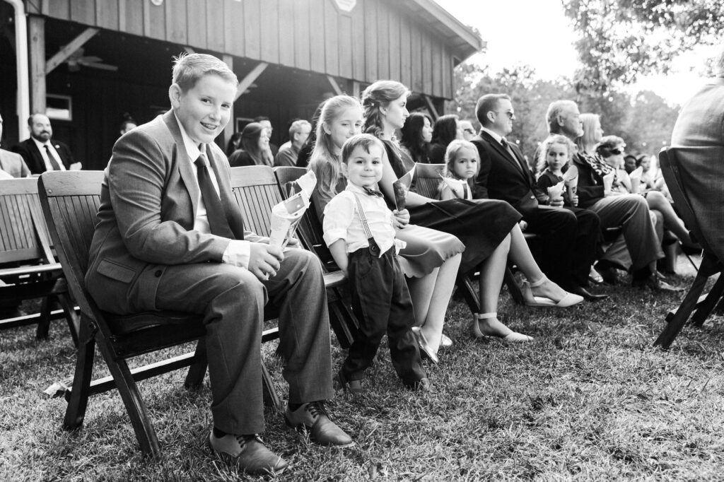 Guests smiling during ceremony. Wedding at Flat Rock Farms.