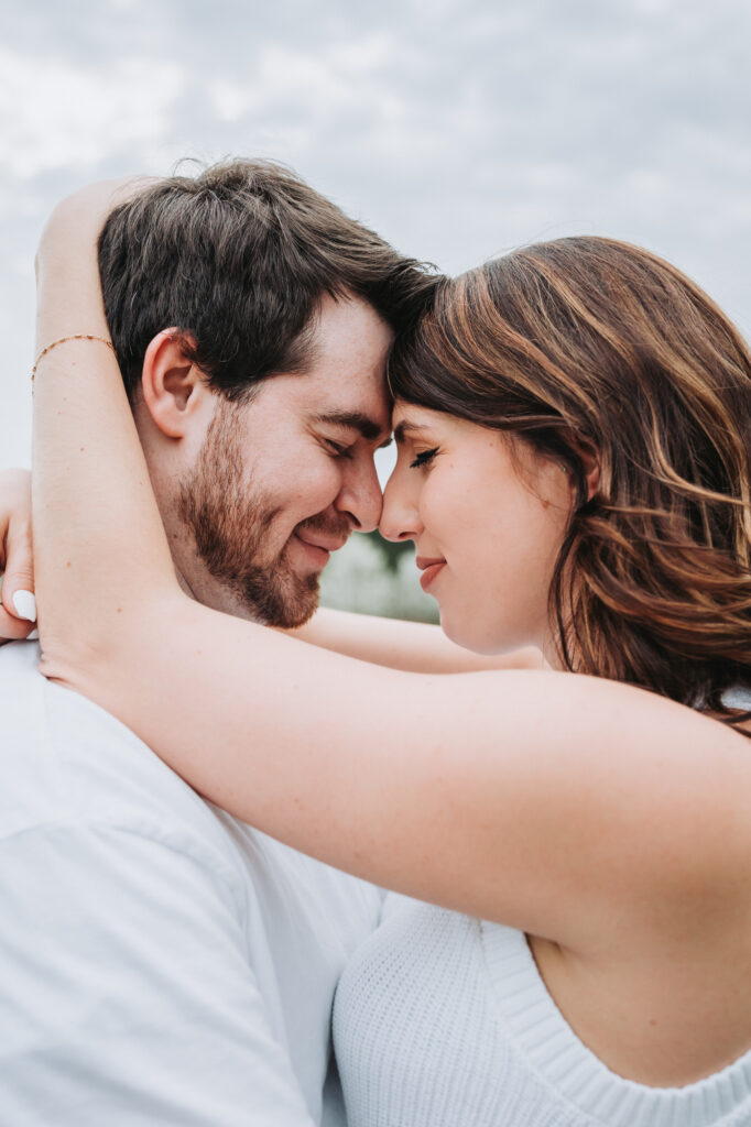 Man and woman touch foreheads during engagement session at Garrard Landing park.