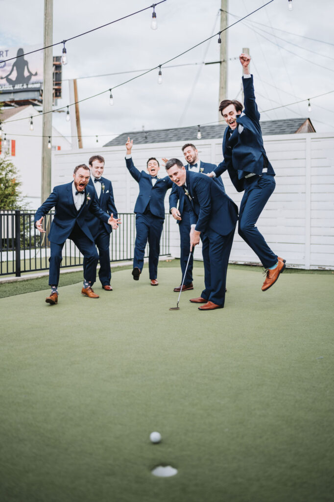 Groom and groomsmen play putt putt. Wedding at Brick and Ivey, Atlanta, GA.