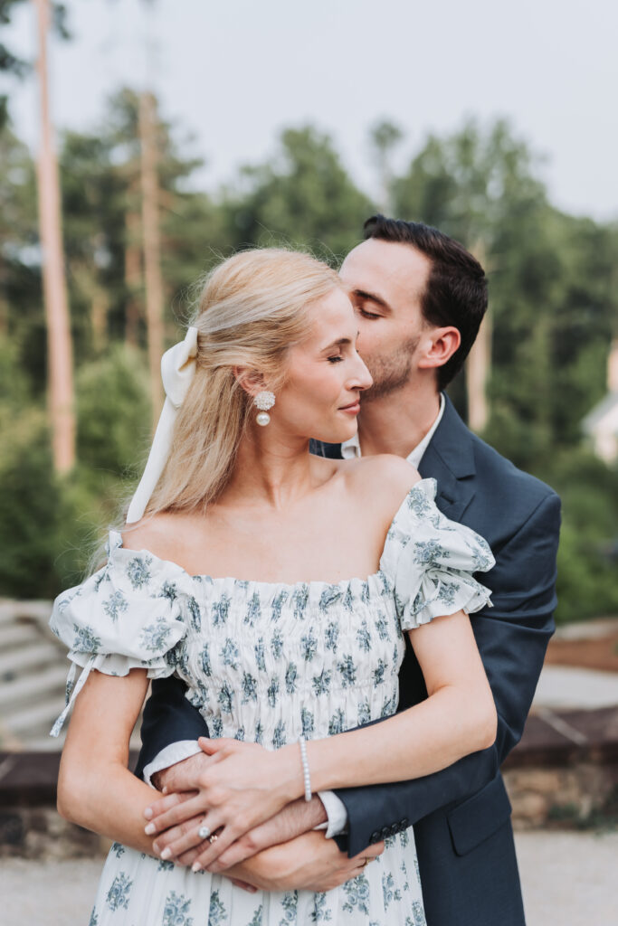 Man kisses woman's cheek. Engagement photos at Serenbe