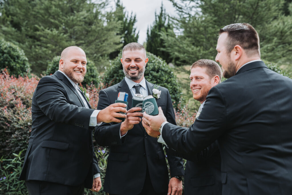 Groom and groomsmen cheers with their drinks.