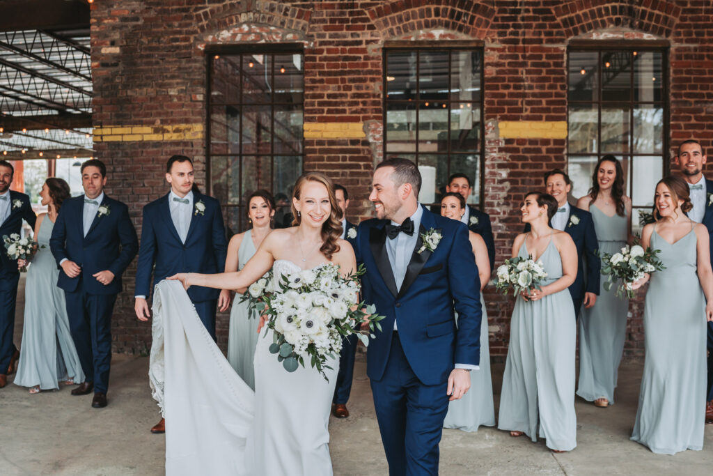Wedding party walk towards camera at Guardian Works wedding venue.