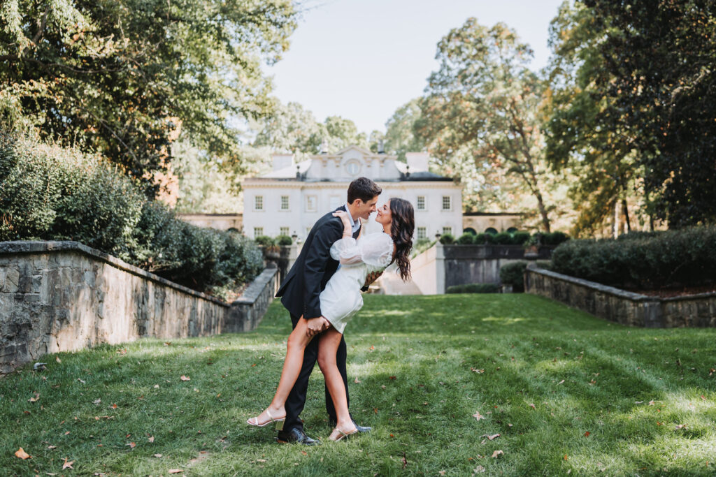 Swan House at Atlanta History Center. Engaged Couple poses outside of swan house