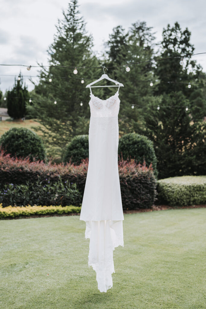 Wedding dress hanging from string lights