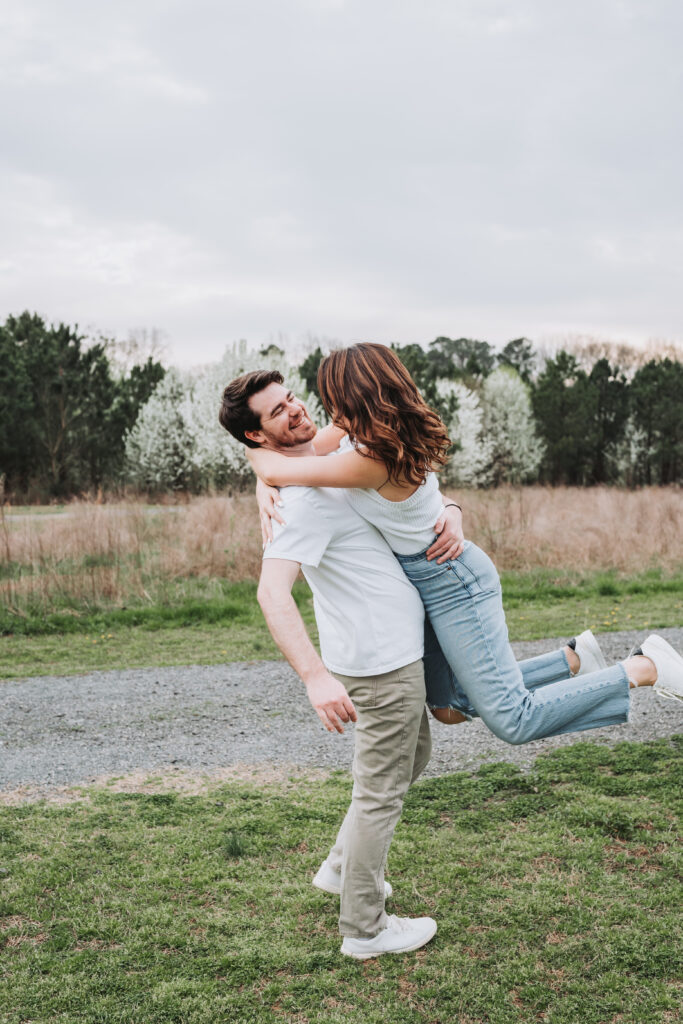Guy spins girl during their engagement session at Garrard Landing Park.