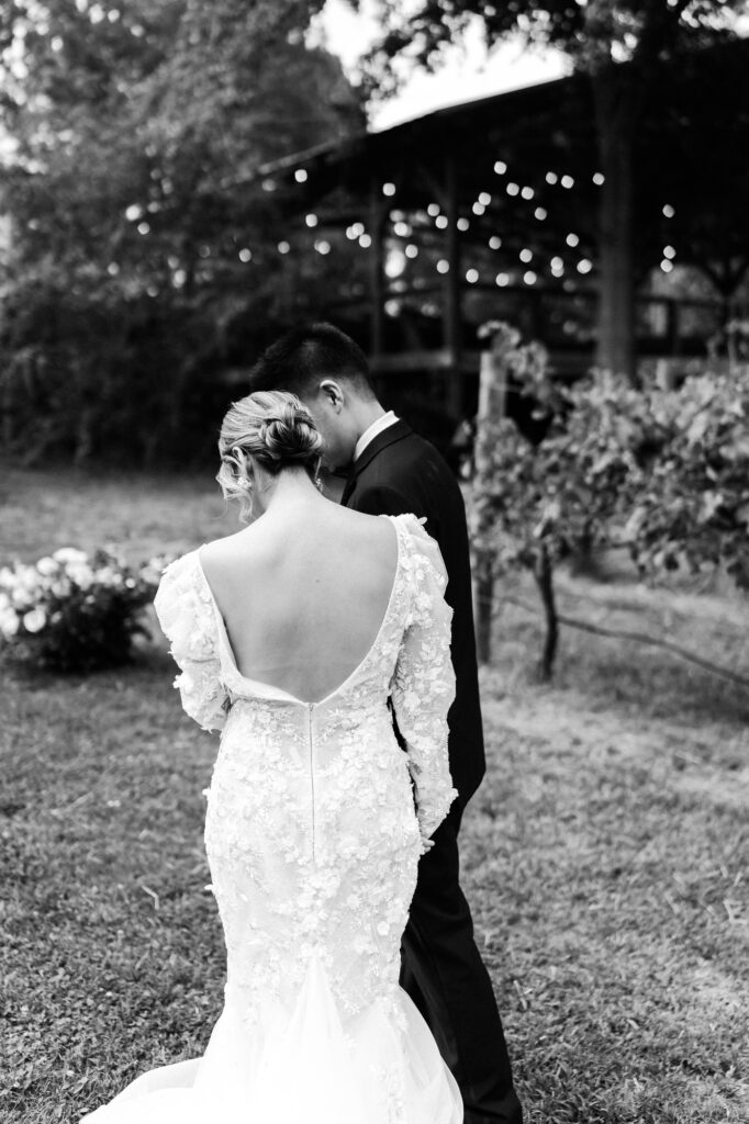Groom guides bride towards ceremony area