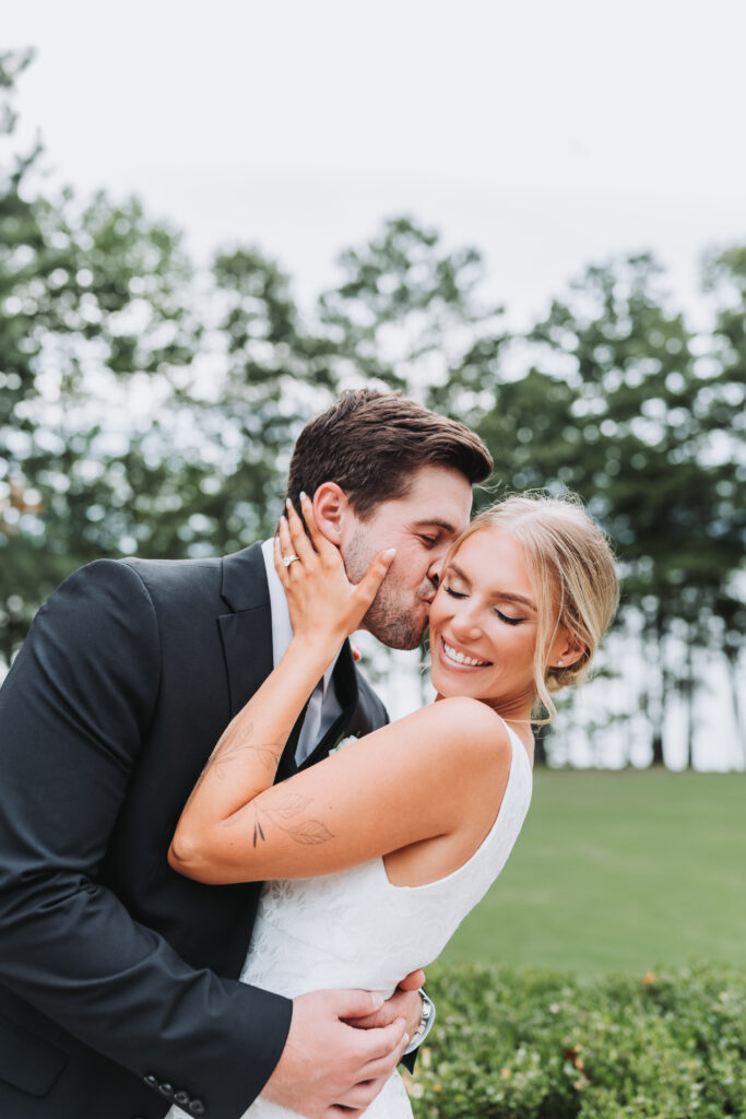 Guy kisses girls cheek at Lake Lanier in Georgia.