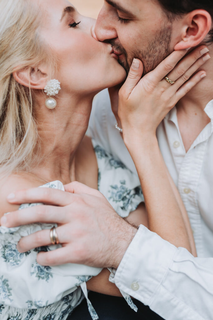 girls holds guys face and kisses him