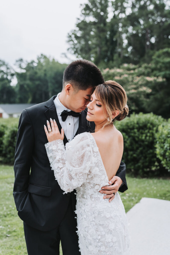 Groom pulls bride in close at their wedding at Koury Farms