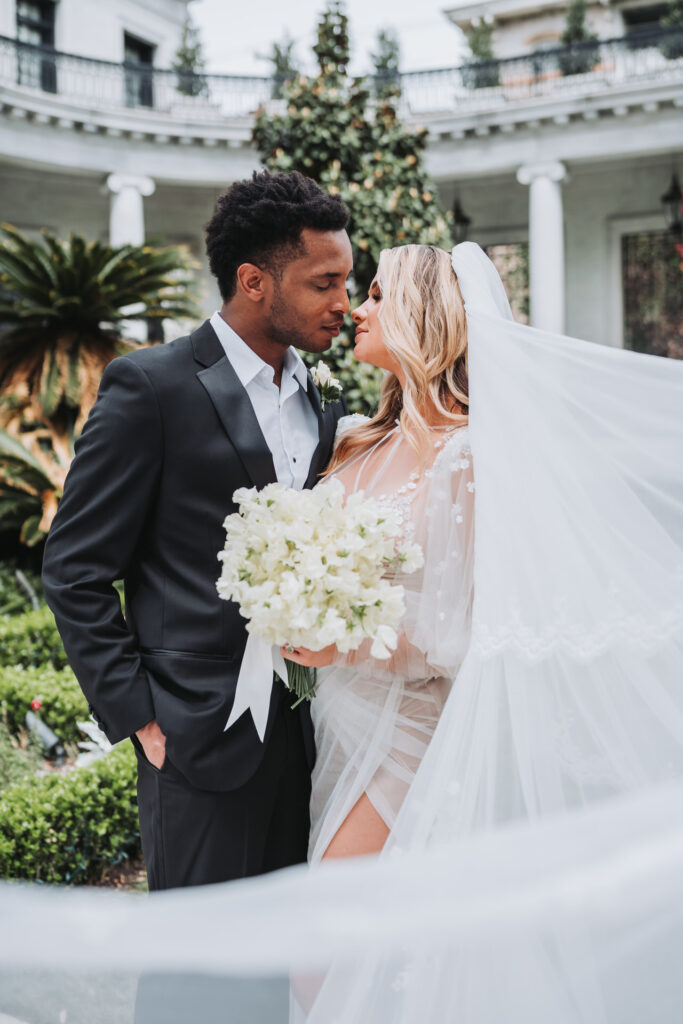 Bride and groom kiss at Armstrong Kessler Mansion wedding in Savannah Georgia.