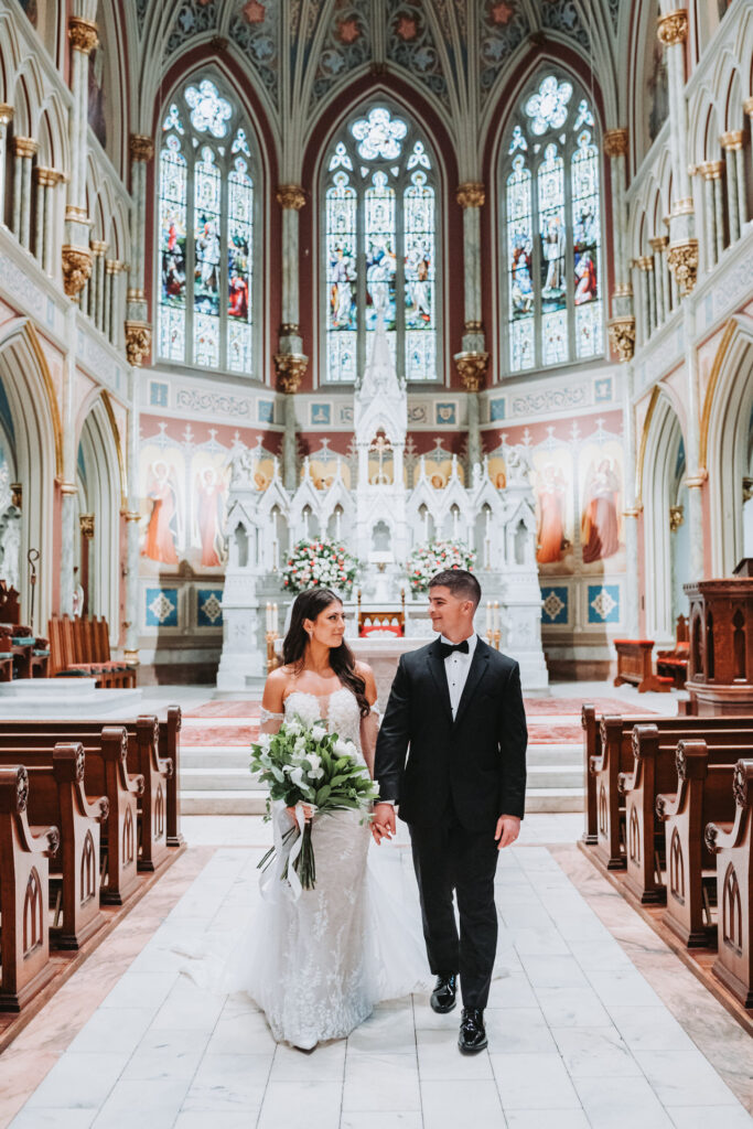 Bride and Groom walk down the aisle at Cathedral Basilica of St. John the Baptist in Savannah Georgia