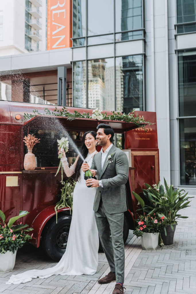 bride and groom pop champagne bottle