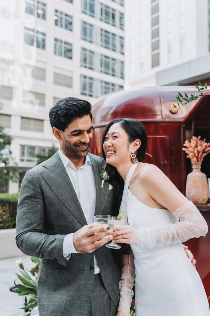 bride and groom laugh at one another during photos