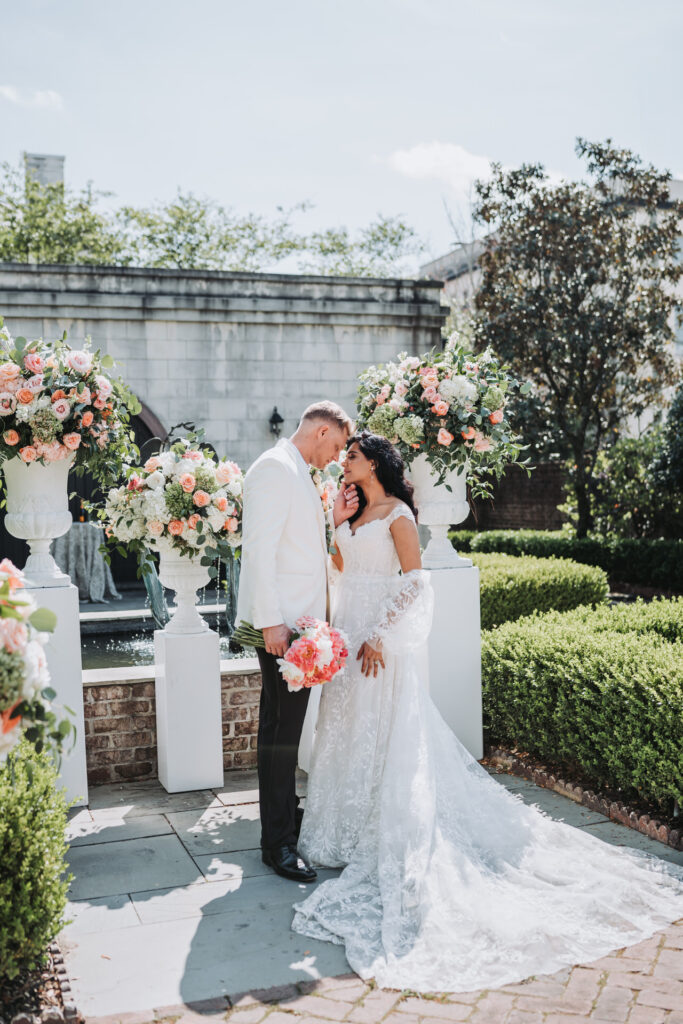 Groom holds brides chin at wedding ceremony site