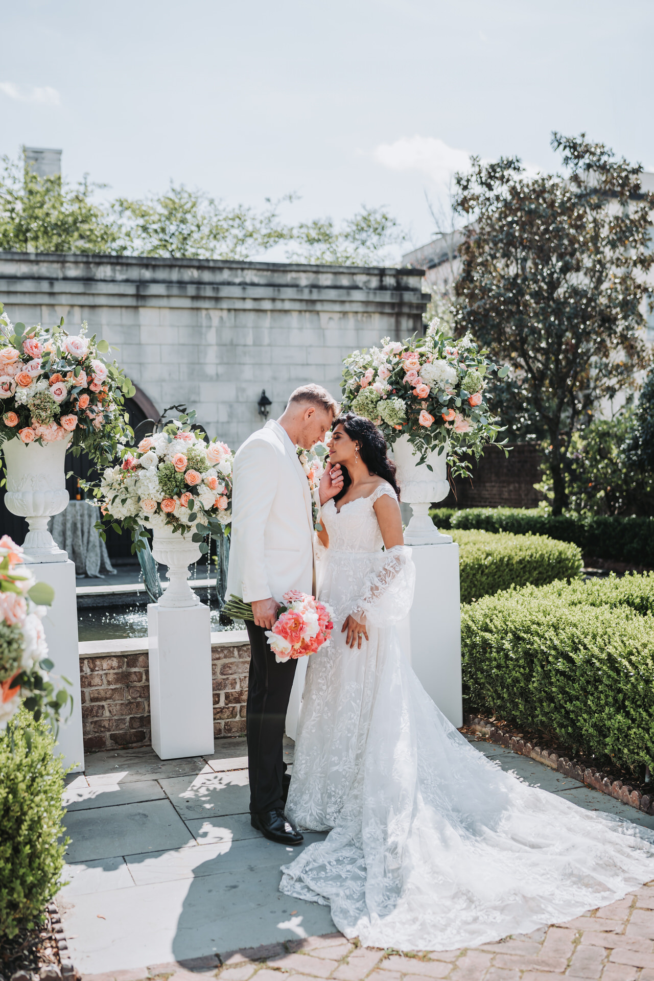 Groom holds brides chin at wedding ceremony site