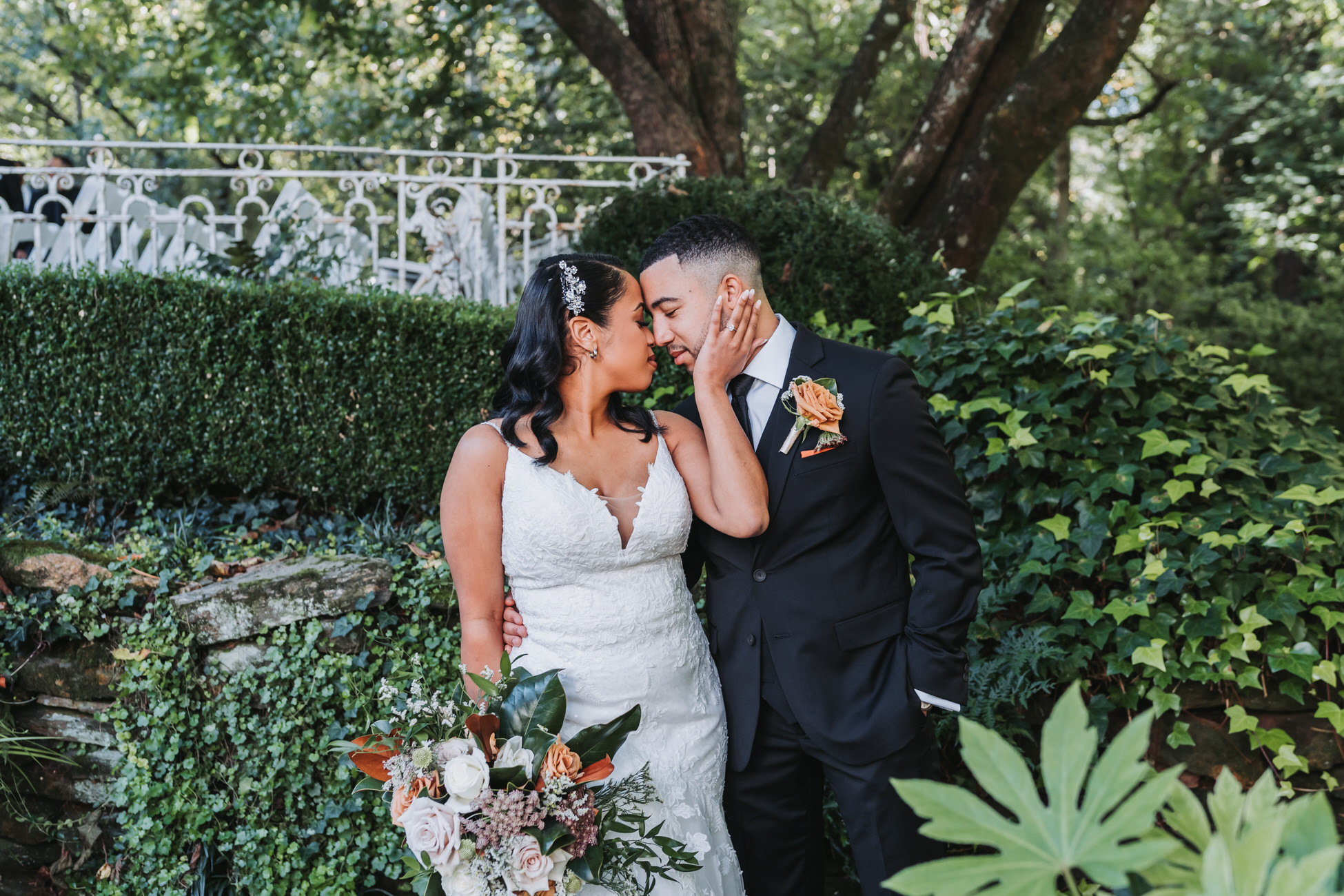 Bride holds groom's face during fall wedding photos