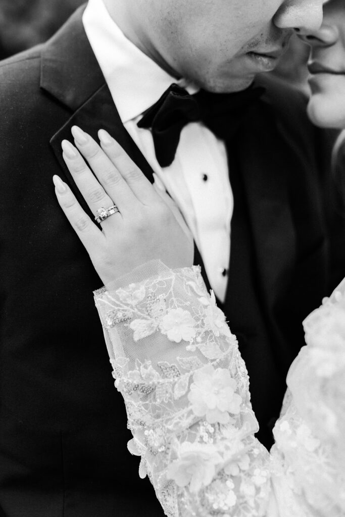 Bride and groom being photographed embracing at their wedding