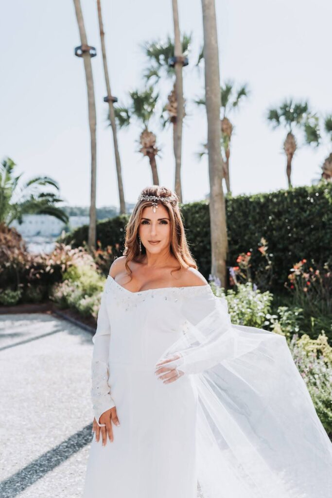 a bride being photographed in front of trees