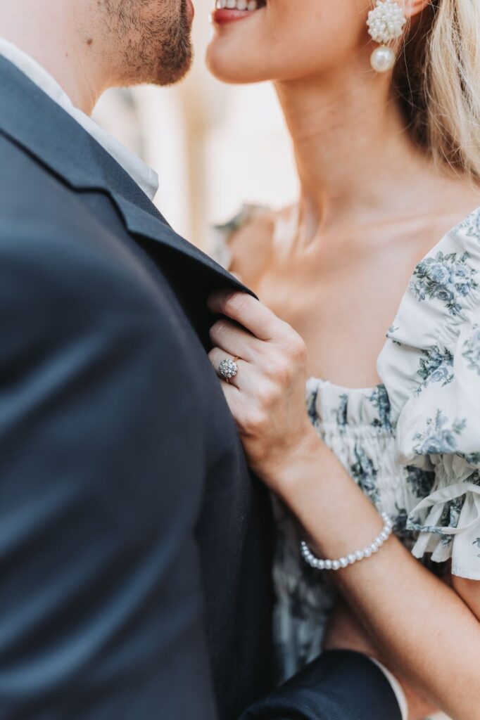 engaged couple hugging with engagement ring visible