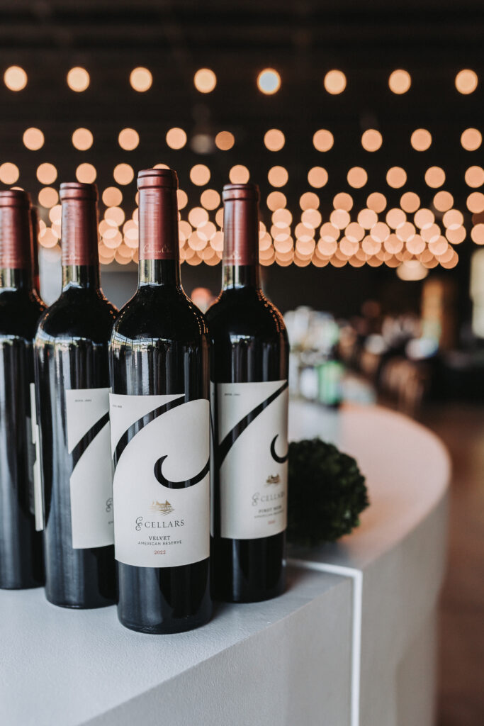 Château Élan Wine bottles with twinkling lights in the background.