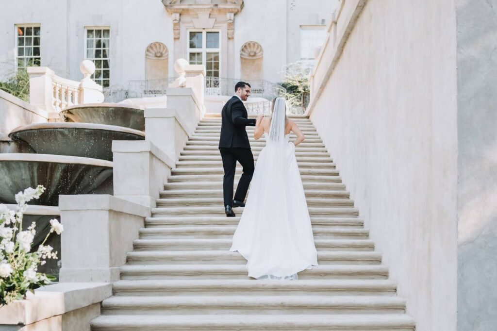 Couple walks up the steps of the Swan House wedding venue