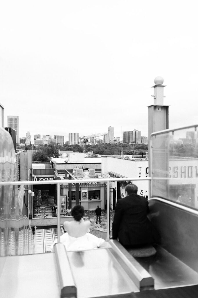 bride and groom slide down slide at Ponce City Rooftop