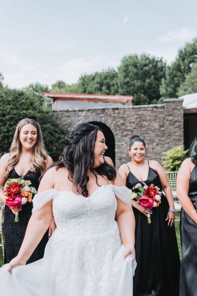 Bride laughs with bridesmaids at piedmont room wedding venue