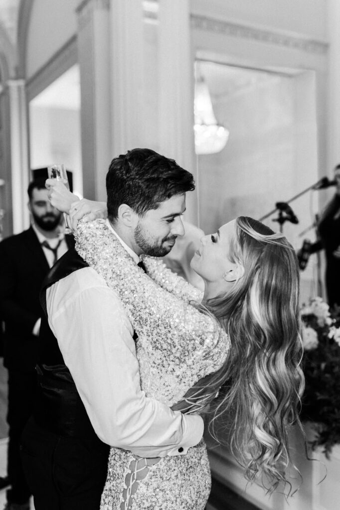 Bride and groom look at each other while dancing
