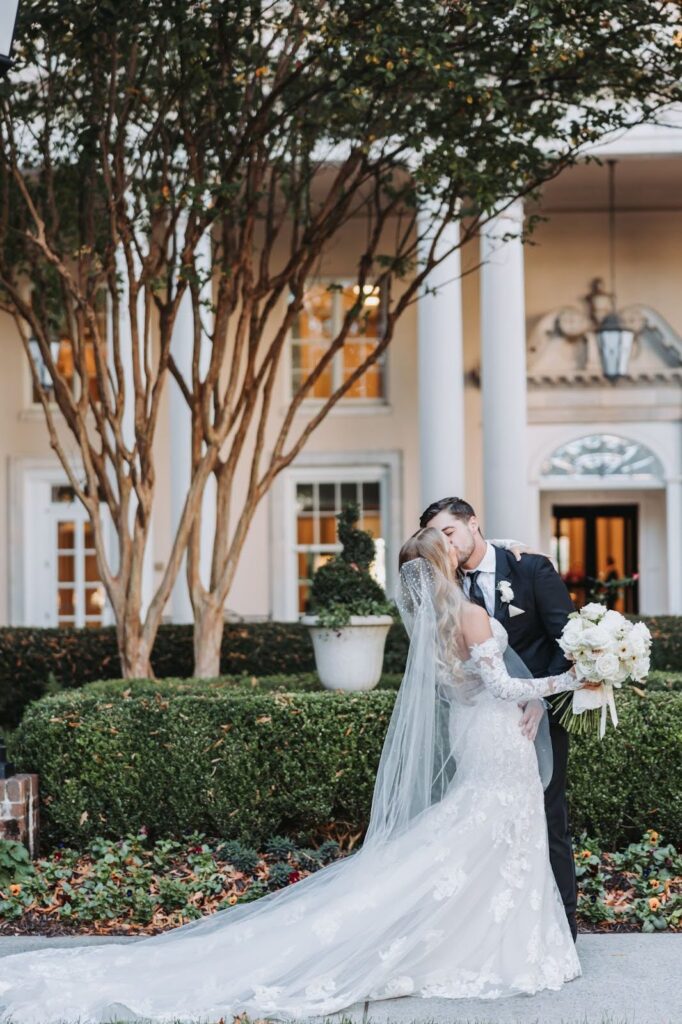 couple kisses in front of biltmore ballrooms