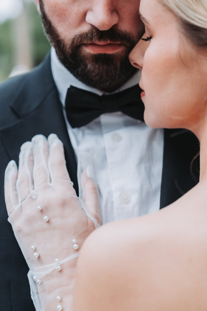 bride wears pearl arm sleeves.