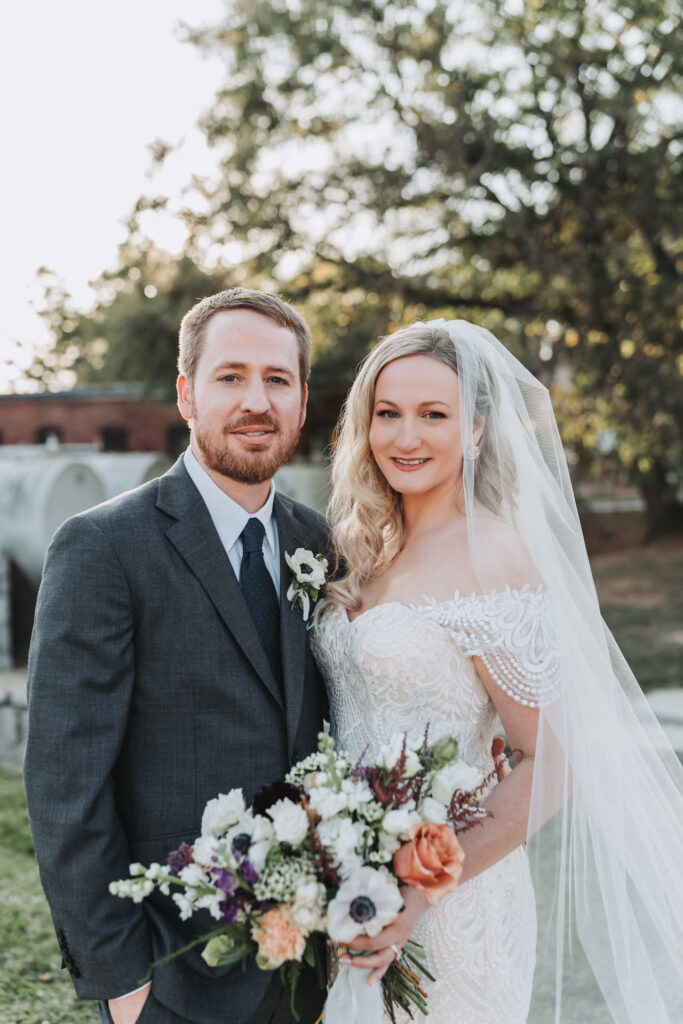 Bride and groom smile at camera