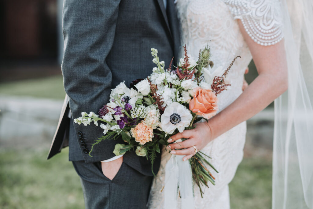 Close up of bride holding wedding bouquet. 