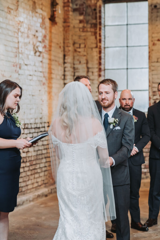 Groom holds bride's hands