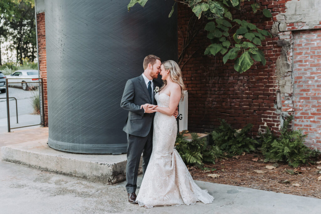 Bride and groom hold each other as they look at each other. 