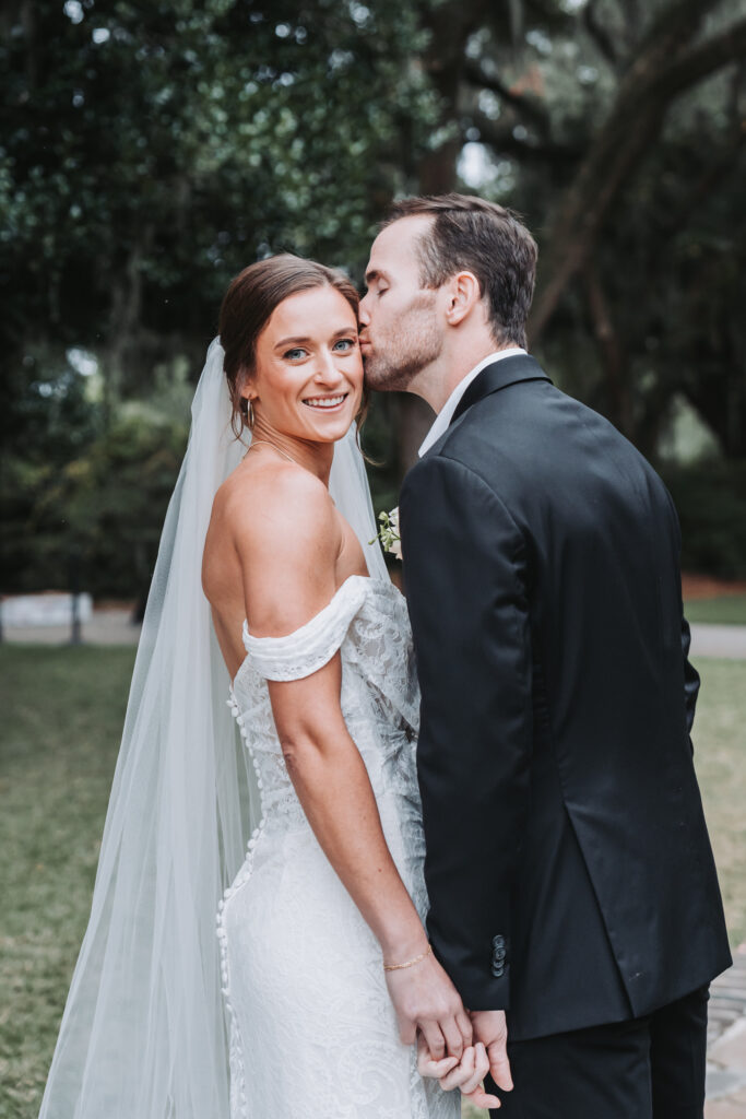 Groom kisses bride's cheek