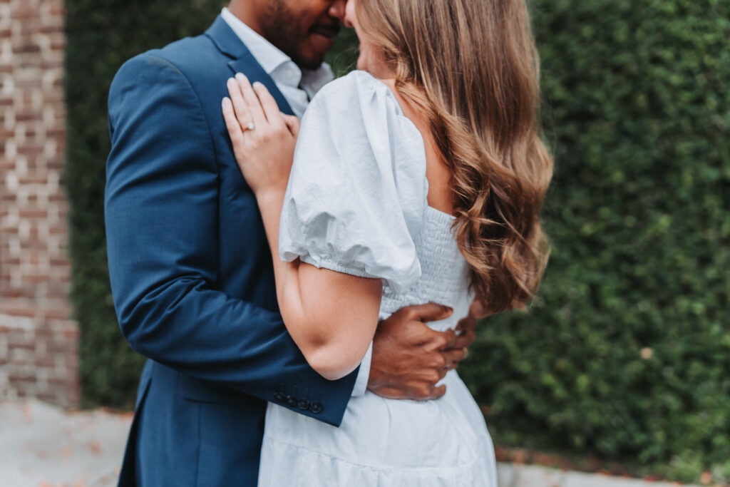girl and guy hold each other close.