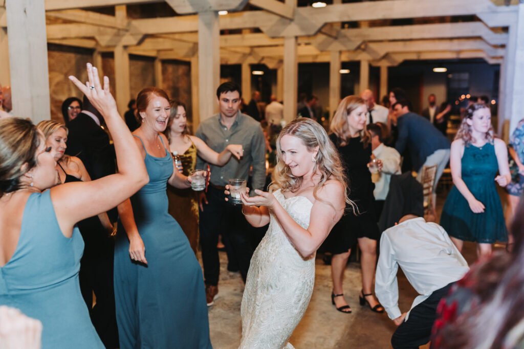 bride dances with bridesmaids