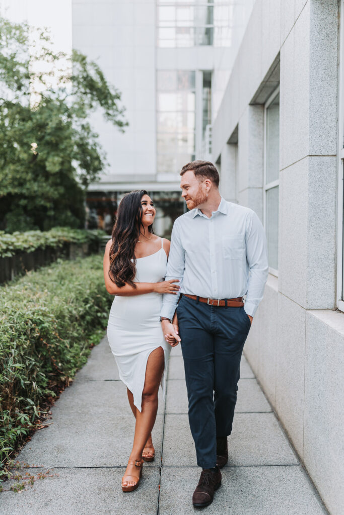 girl and guy walk towards camera while looking at each other.