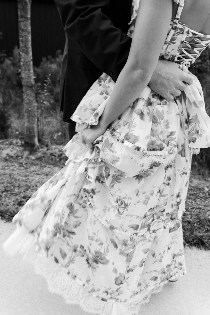 girl plays with her flowy engagement dress