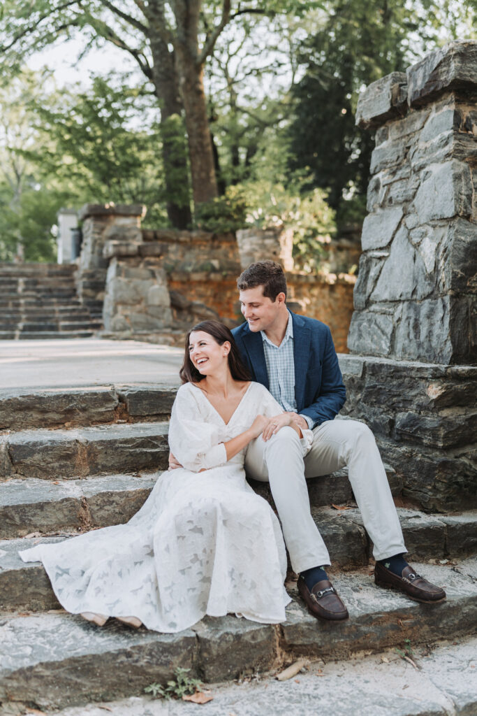 girl laughs and guy looks at her while sitting on steps