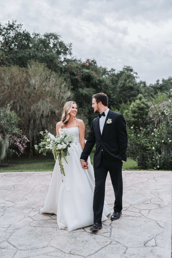 bride and groom walk towards camera at legare waring house wedding