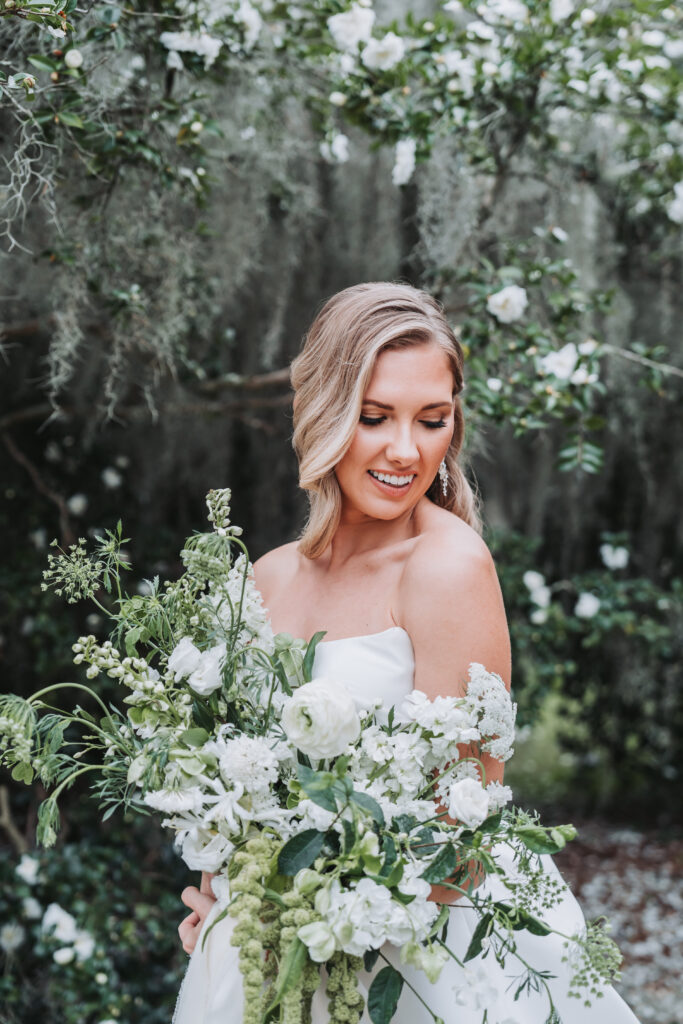 Bride looks down at her bouquet